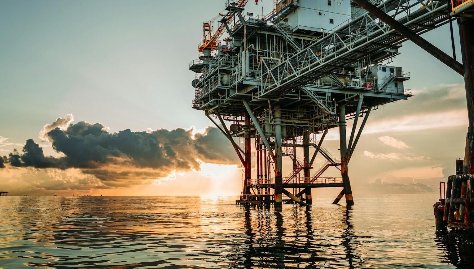 Offshore oil platform at sunset